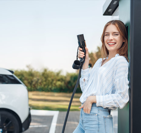 Kobieta trzymająca ładowarkę do auta elektrycznego