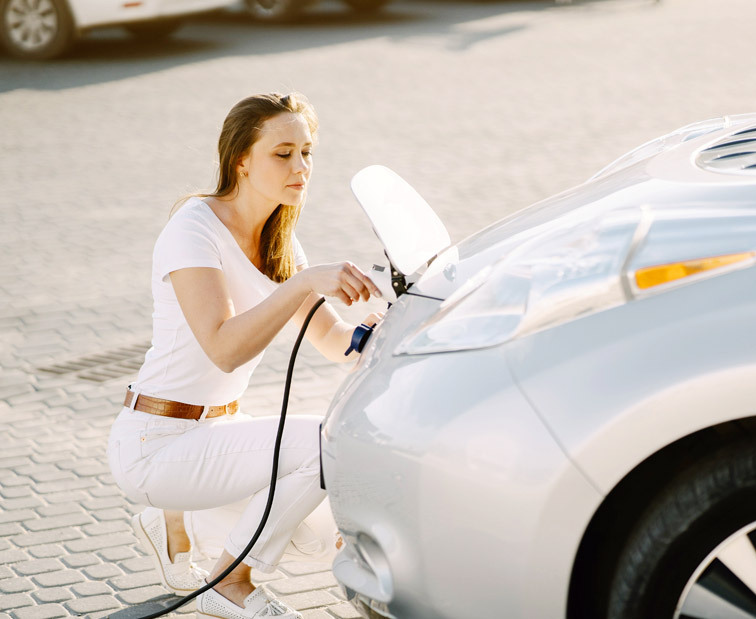 Kobieta ładująca samochód elektryczny